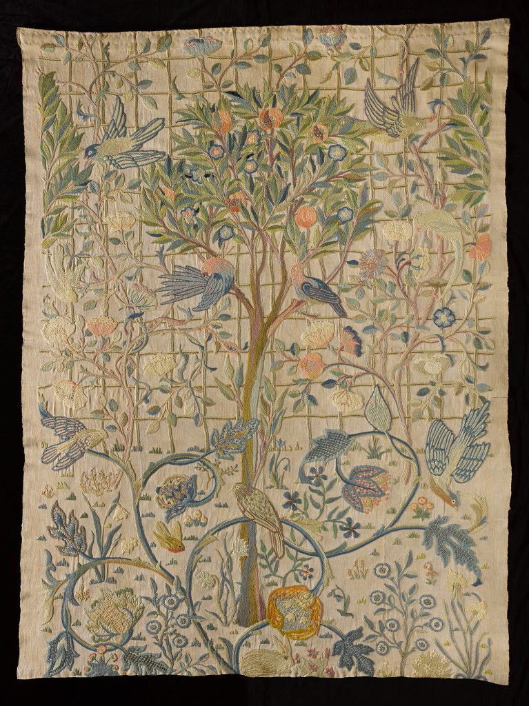 Tenture brodée de laine sur lin représentant un grenadier, des roses et autres fleurs, feuillages et oiseaux.